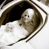 Beautiful Bride arrives at wedding in white stretch limousine